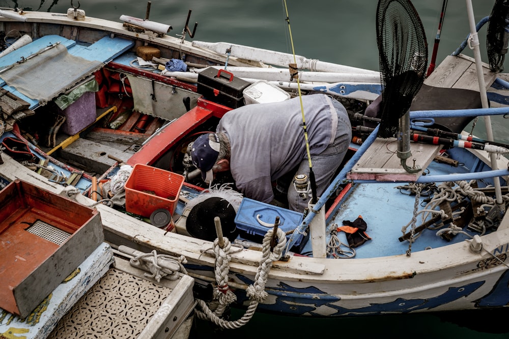 Technician inspecting a used boat outboard engine before sale